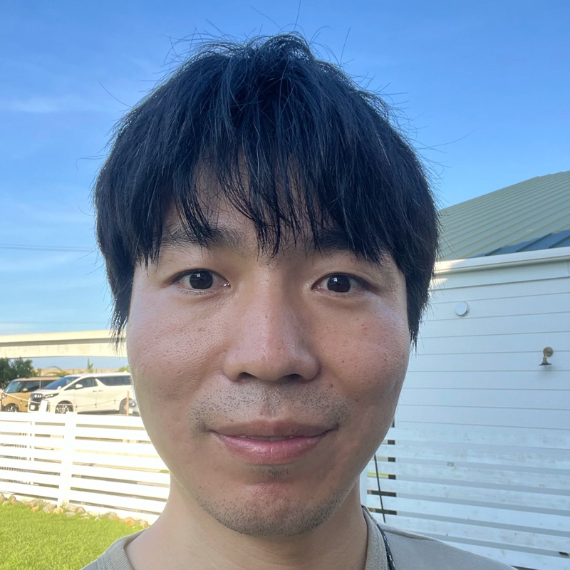 Portrait of Shinya Uryu, outdoors under a blue sky.